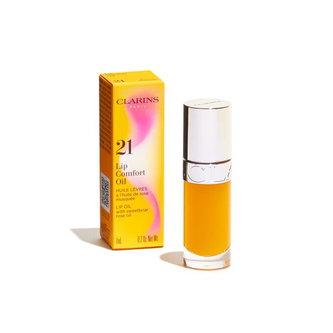 Plan produit de l’Huile Confort Lèvres jaune Clarins issue de la collection Pouvoir des Couleurs, présentée avec son emballage