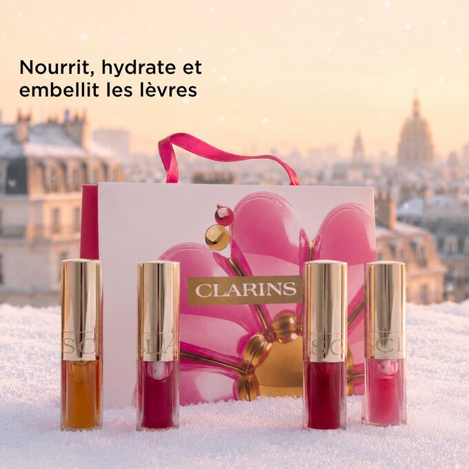Plan produit du coffret cadeau de No&euml;l Beaut&eacute; de Clarins mettant en avant des huiles &agrave; l&egrave;vres qui nourrissent, hydratent et subliment les l&egrave;vres d&rsquo;une brillance naturelle